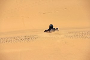 Bodyboarding down the dunes in Swakopmund, Namibia