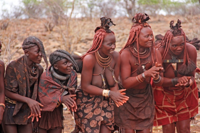 Himba women and girls dancing in traditional dress in Kunene, Namibia