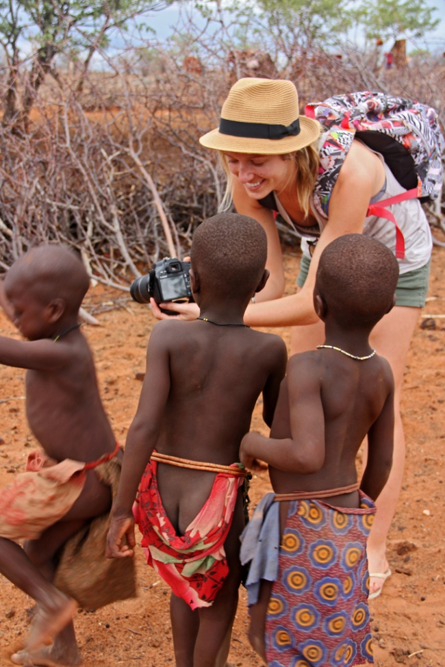 Himba kids in Namibia look at digital photos of themselves